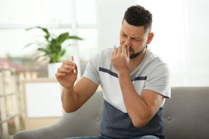 man with nicotine patch and cigarette at home